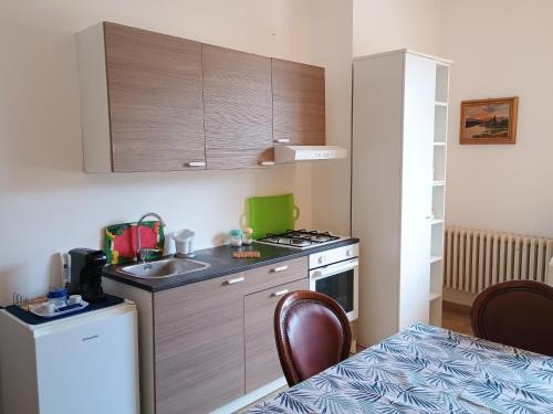 a small kitchen with a sink and a stove at Suites Piazza Umberto in Vignacastrisi