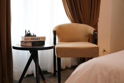 a chair sitting next to a table with a box on it at Penta Square Executive City View Apartments DHA - Phase 5 Lahore in Lahore