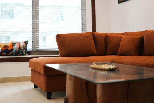 a living room with a couch and a coffee table at Penta Square Executive City View Apartments DHA - Phase 5 Lahore in Lahore