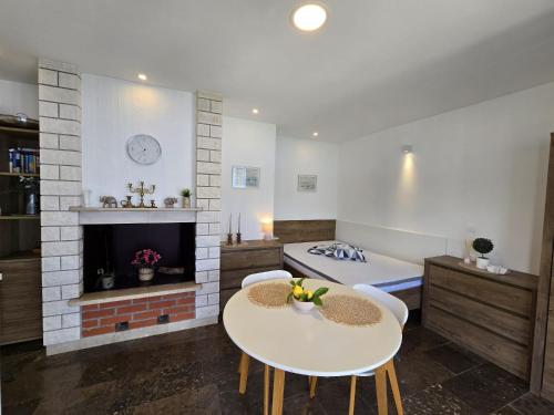 a living room with two tables and a fireplace at Sunset Apartments in Korčula