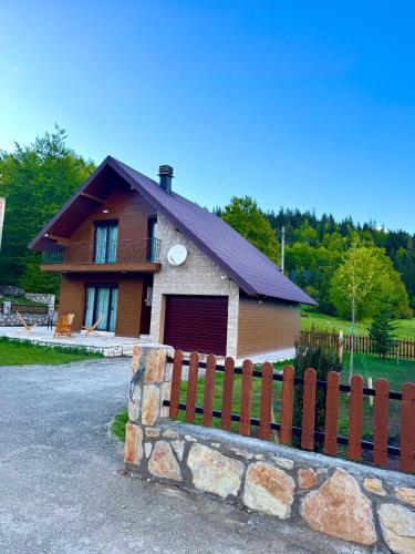 a house with a fence in front of it at North Forest in Žabljak