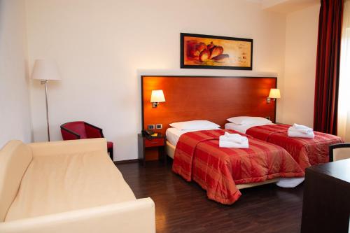 Postel nebo postele na pokoji v ubytování Gullo Hotel
