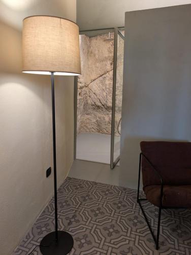 a room with a lamp and a chair and a bed at Casa Avella Mountain Retreat in Pennapiedimonte