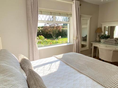 a bedroom with a bed in front of a window at Tranquil Haven Home in Milltown
