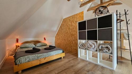 a bedroom with a bed and a book shelf at Gîte Lou Clapas in Salles-la-Source