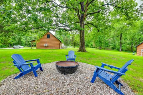 three blue chairs sitting around a fire pit in a yard at Near Mammoth Cave Family-Friendly Cabin with Patio! in Cave City