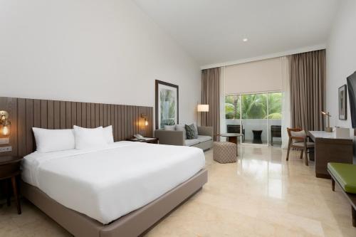 a bedroom with a large bed and a living room at Hyatt Regency Grand Reserve Puerto Rico in Rio Grande