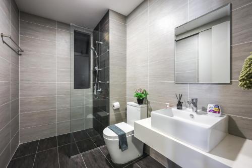 a bathroom with a white toilet and a sink at Trion Kuala Lumpur by Vivid Stay in Kuala Lumpur