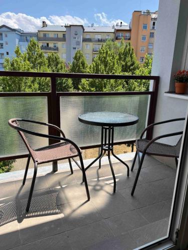 a balcony with a table and two chairs and a table at A large 1 bedroom apartment with an available private parking in Prague