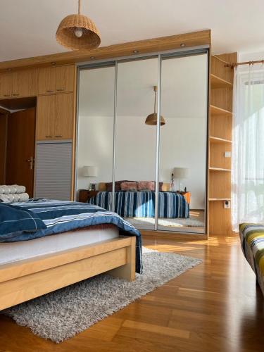 a bedroom with a bed and a large glass wall at A large 1 bedroom apartment with an available private parking in Prague