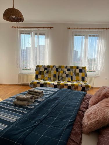 a living room with chairs and a large bed at A large 1 bedroom apartment with an available private parking in Prague