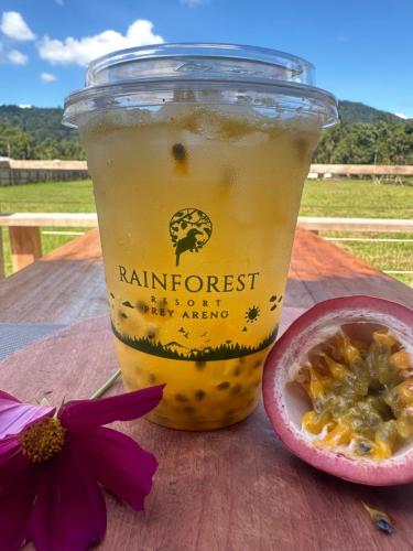 a drink in a cup next to a passion fruit at Rainforest Resort Prey Areng in Phumĭ Triĕt