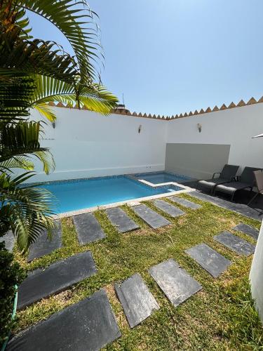 a swimming pool in the backyard of a house at Killamoon House Paracas in Paracas