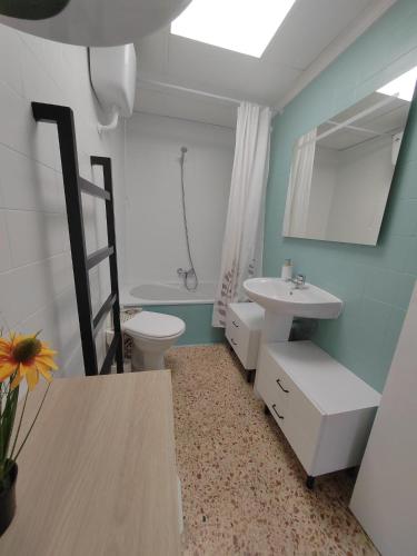 a bathroom with a sink and a toilet and a mirror at Au bord de la plage in Puerto de Sagunto