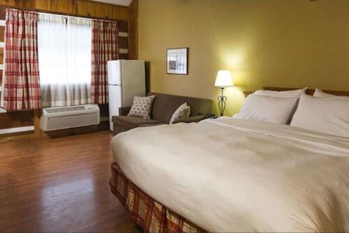 a hotel room with a large bed and a window at Timbers Lodge in Pigeon Forge