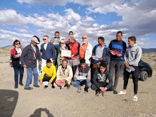 a group of people posing for a picture in the desert at KASBAH Atlas-Aberdouz in Aït Hattab