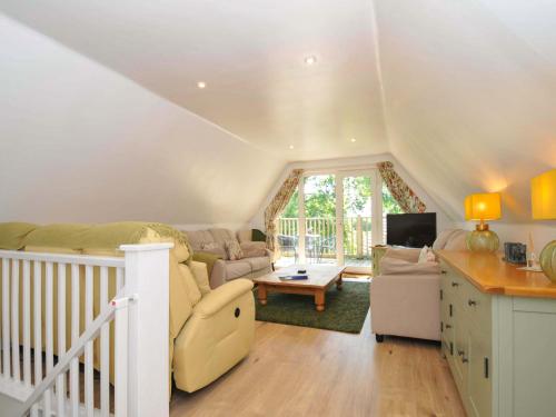 a living room with a couch and a table at 60 Valley Lodge in Callington