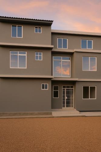 a house with the sunset in the background at Spacious Beachfront Condo -AC - WiFi, Uroa Escape Zanzibar in Uroa