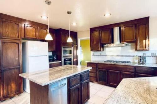 a kitchen with wooden cabinets and a counter top at Vallejo Beautiful 4br Home wt Mountain View Napa in Vallejo