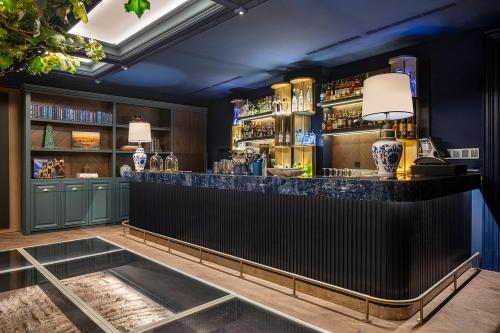a bar with blue walls and a black counter at Komana Hotel Binbirdirek in Istanbul