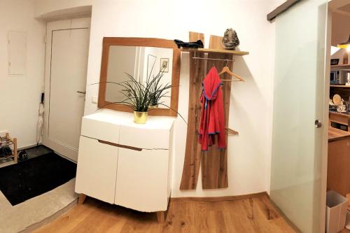 a room with a mirror and a white dresser at Beste Aussicht ins Bergparadies in Eisenerz