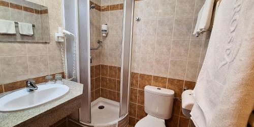 a bathroom with a toilet and a sink and a shower at Hungarospa Thermal Hotel in Hajdúszoboszló