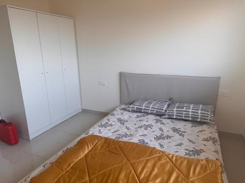a bedroom with a bed and a white cabinet at Rosho homes in Pirangut
