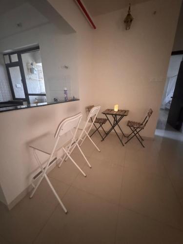 two chairs and a table in a room at Rosho homes in Pirangut
