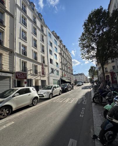 a street with cars parked on the side of a building at Paris Rooms & Dreams Hotel in Paris