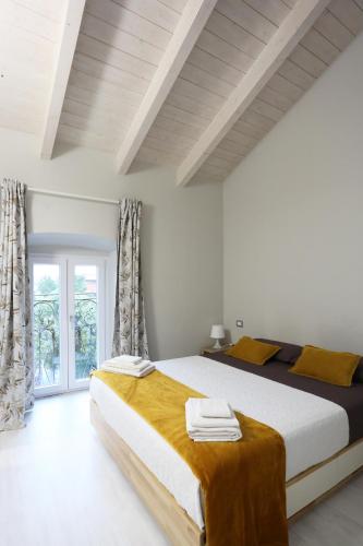 a bedroom with a large bed and a window at New Ulivo Apartment 4 in Seriate