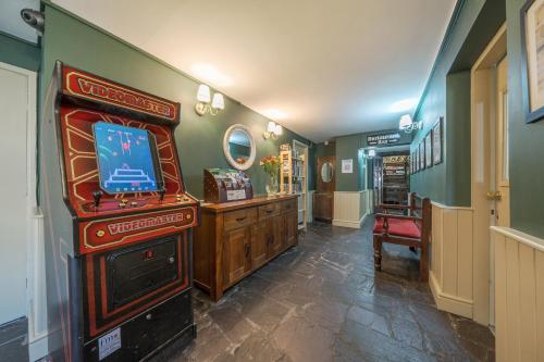 a room with a video game console and a television at The Boars Head Pub in Bishops Castle