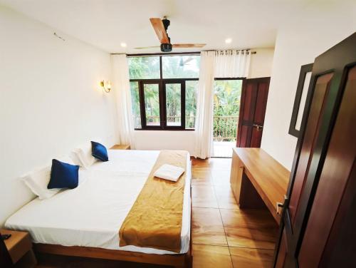 a bedroom with a large bed and a window at Lake view Resort cherai in Cherai Beach