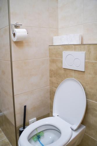 a bathroom with a toilet with the lid up at K-HAUS in Děčín