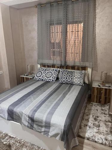 a bedroom with a large bed with two pillows at beach apartment in Fnidek