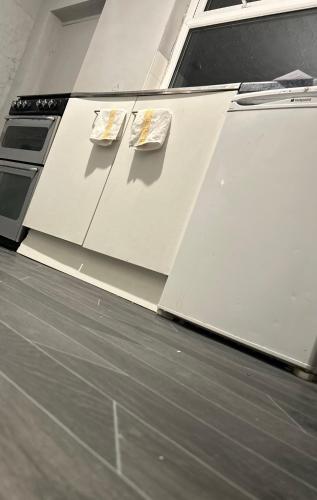 a kitchen with white cabinets with two dishes on them at Accommodatez in Hartlepool