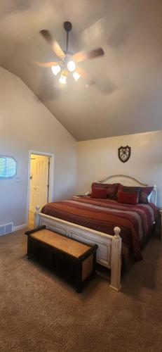a bedroom with a bed with a ceiling fan at Mountain Chalet Near Snowbasin, 2BR in Huntsville