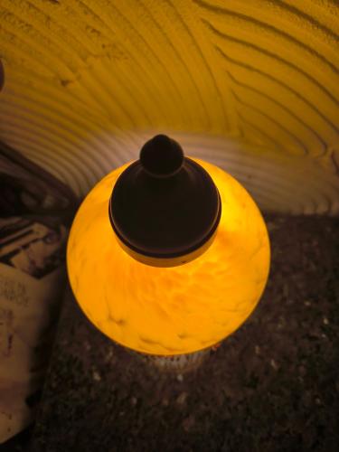 a yellow light with a black hat on top at Tamerici House in Montecastrilli