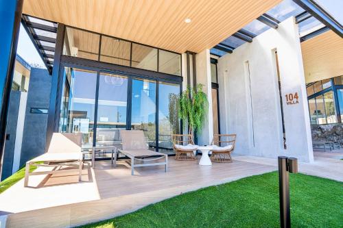 a patio with chairs and a table and glass doors at Epic Tamarindo Boutique Hotel in Tamarindo