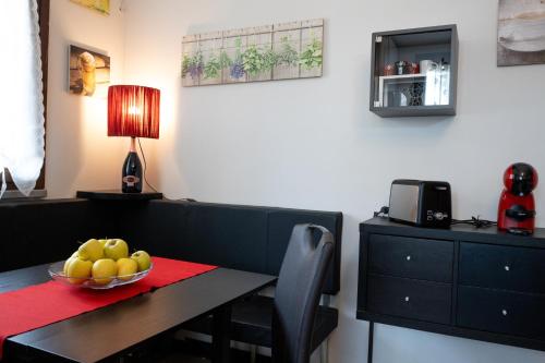 a dining room table with a bowl of fruit on it at lacasadikira in Lucca