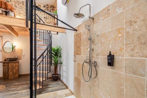 a bathroom with a walk in shower and a staircase at Le loft de la Casa Cota-Balnéo XXL in Rivesaltes