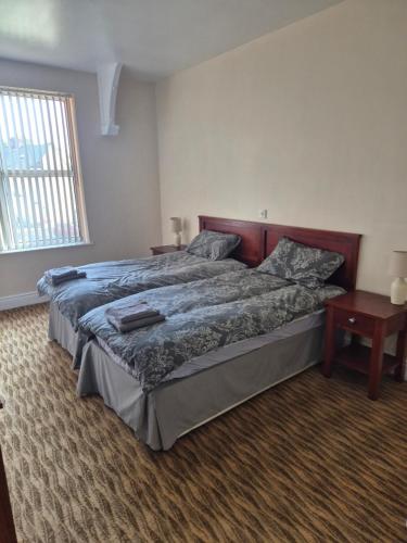 a bedroom with a large bed and a window at The Star Hotel in Cudworth