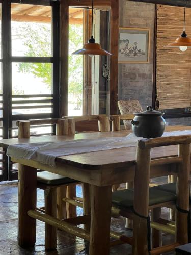 a wooden table with a pot on top of it at La Loica in Barreal
