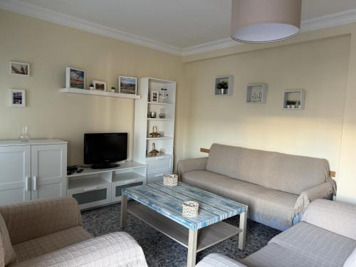 a living room with two couches and a tv at Magnífico piso céntrico in Isla Cristina
