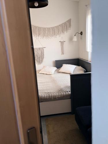 a small bedroom with a bed and a window at Ubytování TradiceJinak in Dolní Dunajovice