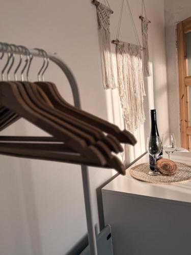 a wine rack with a bottle and a glass on a counter at Ubytování TradiceJinak in Dolní Dunajovice