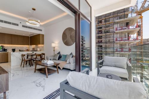 a living room with a couch and a table at GLOBALSTAY Azizi Riviera 59 in Dubai
