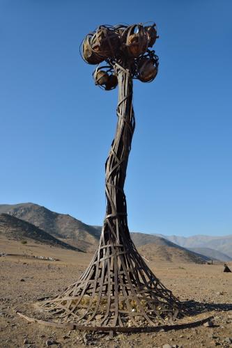 a wooden cross in the middle of a desert at Inca Hoteles in Los Andes