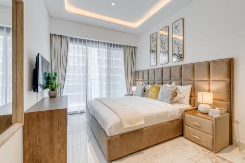a bedroom with a large bed and a large window at GLOBALSTAY Azizi Riviera 59 in Dubai
