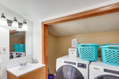 a laundry room with a washing machine and a sink at Serene Devils Lake House with Deck and Fire Pit! in Devils Lake