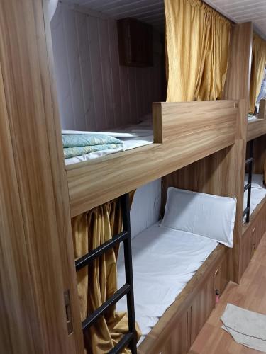 a room with two bunk beds and a ladder at Sun Shine AC Dormitory in Mumbai